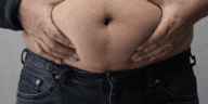 belly fat not reducing despite dieting concept with measuring tape around waist and weighing scale